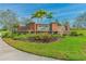 Southfork Lakes entrance sign with brick pillars, beautiful landscaping, and sunny blue skies at 14206 Covert Green Pl, Riverview, FL 33579