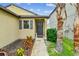 Well-maintained front entrance featuring lush landscaping and a covered doorway at 14206 Covert Green Pl, Riverview, FL 33579