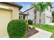 Close up of single-Gathering home with manicured lawn, palm trees, and updated landscaping at 14206 Covert Green Pl, Riverview, FL 33579