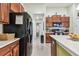 Well-equipped kitchen features modern appliances, tile floors, and ample cabinet space at 14206 Covert Green Pl, Riverview, FL 33579