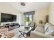 Inviting living room featuring tile floors, ample natural light, and a seamless connection to the outdoors through sliding doors at 14206 Covert Green Pl, Riverview, FL 33579