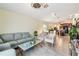 Open-concept living space combines living and dining areas, featuring tile floors and comfortable seating arrangements at 14206 Covert Green Pl, Riverview, FL 33579