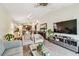 Bright living room with tile flooring, flowing layout, and seamless transition to the dining area and kitchen at 14206 Covert Green Pl, Riverview, FL 33579