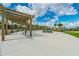 A common area with a pergola has tables and chairs for relaxing and socializing at 14206 Covert Green Pl, Riverview, FL 33579