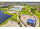 Aerial view of playground with slides, jungle gym, and pool/clubhouse at 14206 Covert Green Pl, Riverview, FL 33579