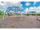 Community playground area featuring a climbing structure and other recreational equipment on a sunny day at 14206 Covert Green Pl, Riverview, FL 33579