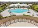 Aerial view of community pool and shaded outdoor lounge area with a pergola at 14206 Covert Green Pl, Riverview, FL 33579