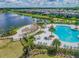Aerial view of community pool and shaded outdoor lounge area with a pergola at 14206 Covert Green Pl, Riverview, FL 33579