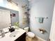Stylish bathroom featuring a modern vanity, decorative shelving, and updated fixtures at 1427 Hillview Ln, Tarpon Springs, FL 34689