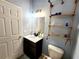 Stylish bathroom featuring a modern vanity, decorative shelving, and updated fixtures at 1427 Hillview Ln, Tarpon Springs, FL 34689