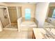 Bathroom featuring a walk-in shower, tub, and vanity at 1427 Hillview Ln, Tarpon Springs, FL 34689