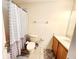 Bathroom featuring a shower/tub combo, toilet, and sink with cabinet at 1427 Hillview Ln, Tarpon Springs, FL 34689
