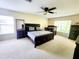 Spacious bedroom featuring a crib, ceiling fan, and dresser at 1427 Hillview Ln, Tarpon Springs, FL 34689