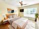 Bright bedroom with a ceiling fan, lots of light from the windows, and hardwood flooring at 1427 Hillview Ln, Tarpon Springs, FL 34689