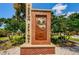 Tarpon Springs community entrance sign with historic marker and lush landscaping at 1427 Hillview Ln, Tarpon Springs, FL 34689