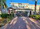 Charming townhome features a two-car garage, brick accents, and mature landscaping in a well-maintained community at 1427 Hillview Ln, Tarpon Springs, FL 34689