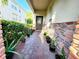 Welcoming front porch with brick accents, potted plants, and a charming entrance to a lovely residential home at 1427 Hillview Ln, Tarpon Springs, FL 34689