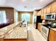 Bright kitchen features a granite-topped island, stainless steel appliances, and wood cabinets at 1427 Hillview Ln, Tarpon Springs, FL 34689