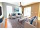 Inviting living room with ample natural light, neutral tones, a plush sofa, armchairs, and stylish decor, perfect for relaxation at 1427 Hillview Ln, Tarpon Springs, FL 34689