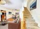 Open-concept living area blends seamlessly with the staircase, dining area, and kitchen, creating a spacious and inviting atmosphere at 1427 Hillview Ln, Tarpon Springs, FL 34689