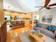 Open-concept living space with hardwood floors, a modern kitchen, and a comfortable seating area for relaxation and entertainment at 1427 Hillview Ln, Tarpon Springs, FL 34689