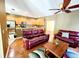 Open-concept living space with hardwood floors, a modern kitchen, and a comfortable seating area for relaxation and entertainment at 1427 Hillview Ln, Tarpon Springs, FL 34689