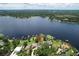 Picturesque aerial view of lakefront properties with lush landscaping, private docks, and serene waters at 14808 Lake Magdalene Cir, Tampa, FL 33613