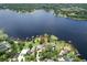 Breathtaking aerial view of a community on a serene lake, highlighting lush landscapes and private docks at 14808 Lake Magdalene Cir, Tampa, FL 33613