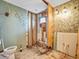 Bathroom awaiting renovation with wall paper and a toilet at 14808 Lake Magdalene Cir, Tampa, FL 33613