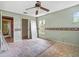 Bedroom awaiting renovation with ceiling fan and natural light at 14808 Lake Magdalene Cir, Tampa, FL 33613