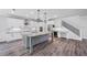 Modern kitchen with stainless steel appliances, a large island, and beautiful hanging pendant lights at 14808 Lake Magdalene Cir, Tampa, FL 33613