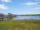 Scenic lake view features a private dock, boat lift, and peaceful waterfront ambiance at 14808 Lake Magdalene Cir, Tampa, FL 33613
