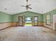Spacious living room awaiting renovation with water view at 14808 Lake Magdalene Cir, Tampa, FL 33613
