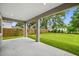 Covered patio overlooking a spacious backyard with a privacy fence and ample greenery at 14808 Lake Magdalene Cir, Tampa, FL 33613