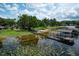 Tranquil lake view featuring a boat dock, lift, and the beauty of waterfront living at 14808 Lake Magdalene Cir, Tampa, FL 33613