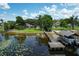 Picturesque lake view with a private dock, boat lift, and serene waterfront scenery at 14808 Lake Magdalene Cir, Tampa, FL 33613