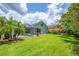 Lush backyard featuring mature trees, a well-manicured lawn and a pool at 15309 Palomapark Ln, Lithia, FL 33547
