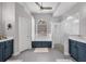 Bright bathroom with dual vanities, tub, and glass-enclosed shower at 15309 Palomapark Ln, Lithia, FL 33547