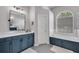 Modern bathroom featuring a tub, shower, and large vanity with dual sinks at 15309 Palomapark Ln, Lithia, FL 33547