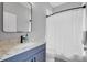 Bathroom featuring a modern vanity, white countertop, and shower with curtain at 15309 Palomapark Ln, Lithia, FL 33547