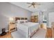 Spacious bedroom featuring a comfortable bed, ceiling fan, and neutral decor at 15309 Palomapark Ln, Lithia, FL 33547