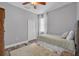 A bedroom featuring carpeted floors, neutral colored walls, and a large window at 15309 Palomapark Ln, Lithia, FL 33547