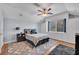 Bright bedroom featuring a bed, ceiling fan, large window, and natural lighting at 15309 Palomapark Ln, Lithia, FL 33547