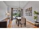 Modern dining room featuring a stylish light fixture, neutral paint, and access to outdoor patio or pool area at 15309 Palomapark Ln, Lithia, FL 33547