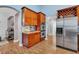 A kitchen area featuring wooden cabinets, stainless steel appliances, and granite countertops at 15309 Palomapark Ln, Lithia, FL 33547