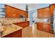 Kitchen features granite countertops, stainless steel appliances, and cherry wood cabinetry at 15309 Palomapark Ln, Lithia, FL 33547