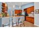 A kitchen featuring wooden cabinets, granite countertops, stainless appliances, and breakfast bar at 15309 Palomapark Ln, Lithia, FL 33547