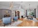 Spacious living room with hardwood floors, modern lighting, and comfortable seating, perfect for relaxation at 15309 Palomapark Ln, Lithia, FL 33547