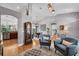 Open-concept living area with hardwood floors and a view of the kitchen and dining area creates space and flow at 15309 Palomapark Ln, Lithia, FL 33547