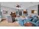 Open concept living room featuring hardwood floors, a ceiling fan, and access to the kitchen at 15309 Palomapark Ln, Lithia, FL 33547